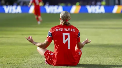 Erling Haaland sits in his celebration pose