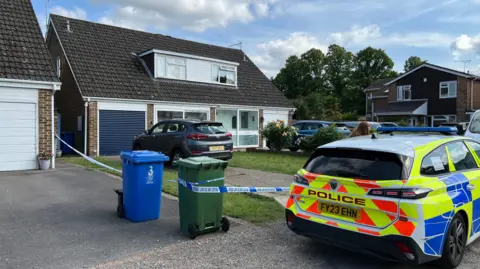 A police car and police tape outside a detached house in Maidenhead.