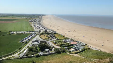 Getty Images View above Brean in Somerset, showing a few houses by a beach.