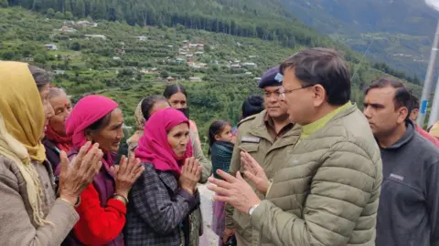 Pushkar Singh Dhami/X Uttarakhand Chief Minister Pushkar Singh Dhami met people affected by the floods on Wednesday
