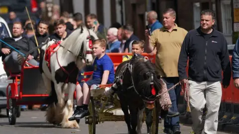 PA Media Crowds lead horse and traps through town