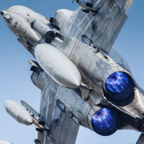 Ben Smith Photography A photo of the Hellenic Air Force F-4 taken by Ben Smith. The jet's engines can be seen shooting brightly coloured flames