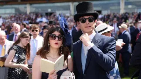 NEIL HALL/EPA/Shutterstock Race-goers attend the first day of Royal Ascot.