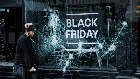 Reuters A glazier remove a broken pane of glass from a shopfront in Dublin city centre