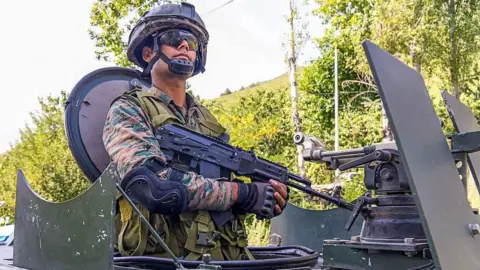 An army man stands guard at Lidwas Meadows of Dara, Srinagar district, India, on July 28, 2025. 