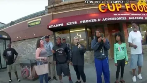 Reuters Darnella Frazier pictured with a group of people watching Floyd's arrest