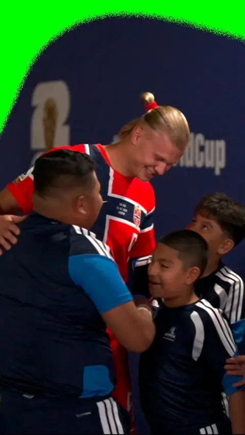 Erling Haaland in tunnel with young mascots