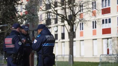 AFP Municipal police officers stand guard near a building on 11 February 2016 in Sarcelles