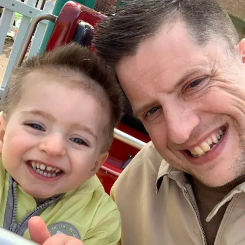 Rhys Llewellyn Albi and Rhys smiling at the camera 