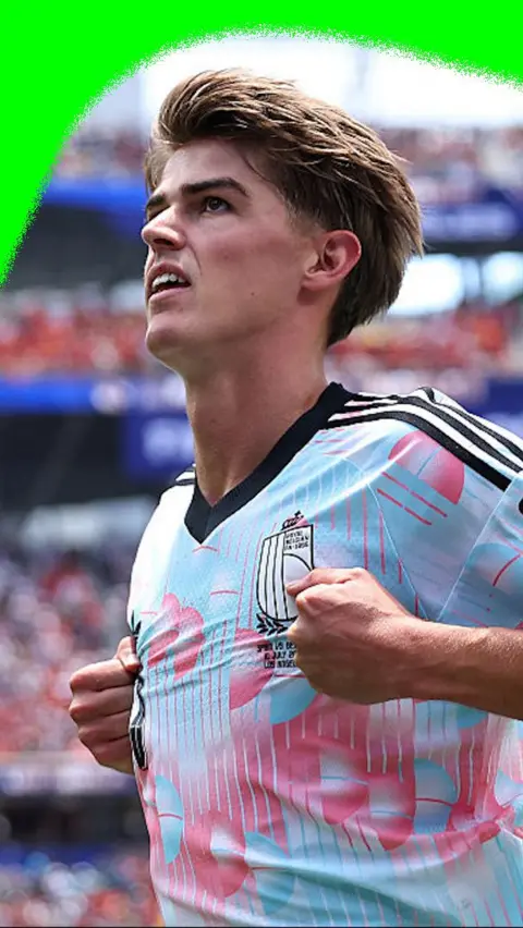 Charles De Ketelaere grabs his shirt while celebrating a goal for Belgium against Spain in the 2026 World Cup.