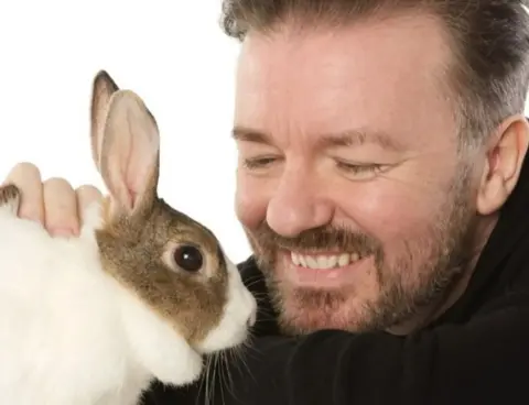 Cruelty Free International Ricky Gervais with a rabbit in publicity photo for Cruelty Free International