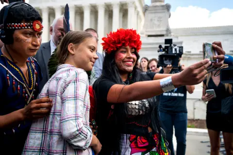 Jim Lo Scalzo/EPA Climate activist Greta Thunberg poses for a selfie with Panamanian climate activist Militza Flaco outside the US Supreme Court in Washington DC, USA. 18 September 2019