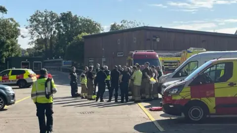 Rescue teams gather near their vehicles in Sunbury