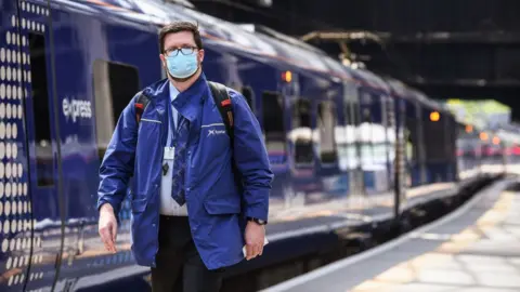 Getty Images ScotRail worker and train