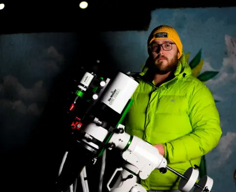 Bryan Shaw  Bryan Shaw holding a telescope