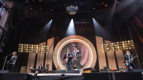 Myles Wright/ZUMA Press Wire via Alamy Alex Turner, Jamie Cook, Nick O'Malley, and Matt Helders of the Arctic Monkeys perform a sold out show in Hillsborough Park, June 2023. 