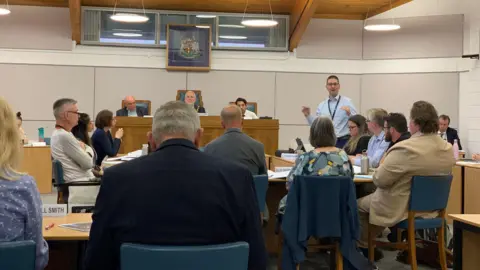 Richard Stanley standing up and talking at Tewkesbury Borough Council's meeting