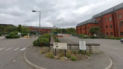 Google The former Lloyds Banking Group call centre site in Farsley, showing red-brick office buildings, parking areas and the main entrance.