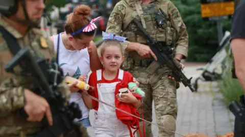 Getty Images Family and police at Highland Park