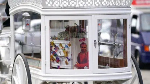 PA Media A photograph of Lilia was displayed in the back of the carriage