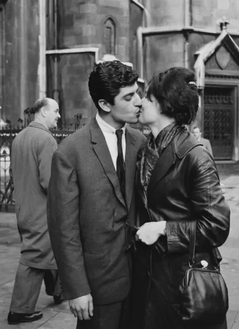Getty Images Bronlio Dario Oliva kisses his partner