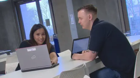 Woman and man working at computers