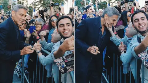 Courtesy of TIFF shot on Huawei P10 Smartphone Elfriede Wolf reaches out and grabs George Clooney's face as he walks the red carpet