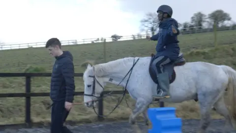 One of the men taking part learning to ride a horse