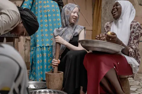 Annika Hammerschlag/Getty Images Penda Fall, a teenager with albinism, helps her family with chores in Dakar, Senegal - Tuesday 13 June 2023