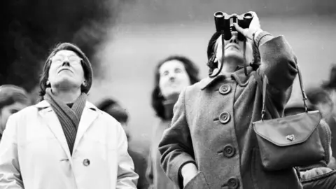 Getty Images Two women gazing skyward