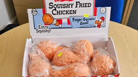 Isle of Man Government A tray of suishy toys resembling fried chicken drumsticks. The toys are called 'Squishy fried chicken'