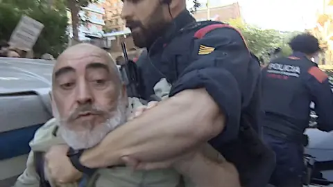 Man being restrained by police officer