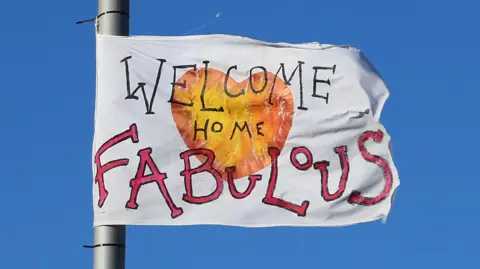 A flag saying "welcome home fabulous" flying on a lamppost in Stourbridge