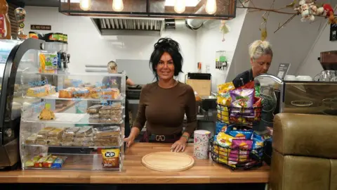 Yasmin Ratcliffe, owner of Rose's Cafe, stands behind the counter in Ashton-in-Makerfield