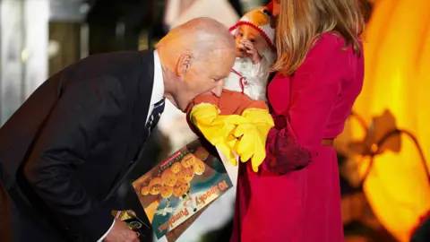 Biden playfully bites baby