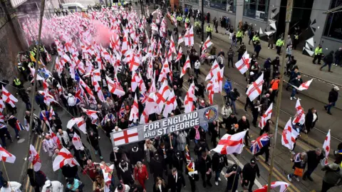 Overhead view of hundreds of Britain First protesters holding St George's flags