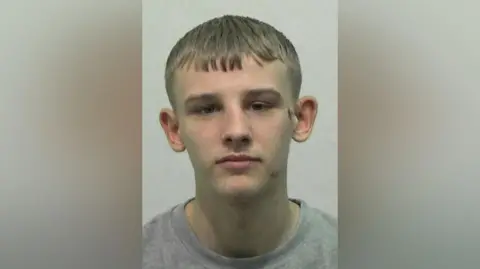 Northumbria Police Mugshot of Mason Ibbotson. He has short blond hair, large ears and is clean shaven.