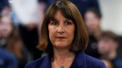 Reuters Rachel Reeves at a campaign event, with people seen blurred in the background
