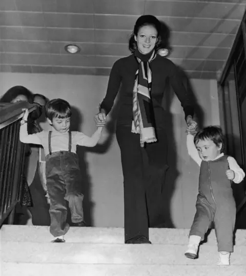 Getty Images English actress Maggie Smith with her two children, Chris Larkin (left) and Toby Stephens, at London Airport, March 1971.