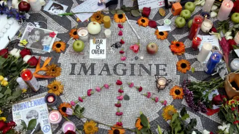 Reuters Fans honour John Lennon with a memorial in Central Park's Strawberry Fields in 2005