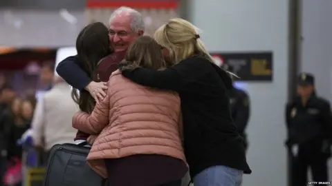 Getty Images Former mayor of Caracas, Antonio Ledezma (2L) meets his wife Mitzy Capriles (C) and daughters at his arrival to Adolfo Suarez Madrid Barajas Airport on November 18, 2017 in Madrid, Spain.