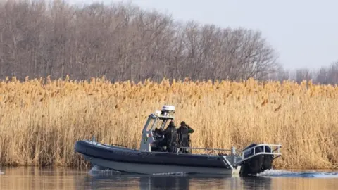 Reuters Police search the marshland where bodies were found in Akwesasne, Quebec, Canada March 31, 2023.