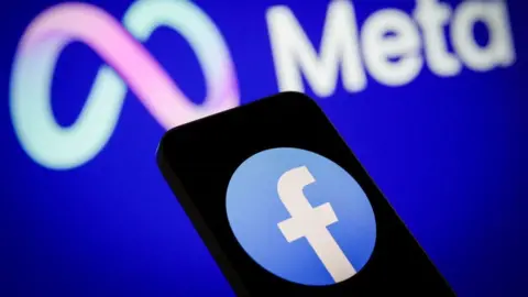 Getty Images The Meta logo is seen with a Facebook logo on a mobile device in this photo illustration on 24 May, 2023 in Warsaw, Poland