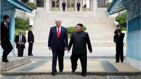 Handout North Korean leader Kim Jong Un and U.S. President Donald Trump inside the demilitarized zone (DMZ) separating the South and North Korea on June 30, 2019 in Panmunjom, South Korea