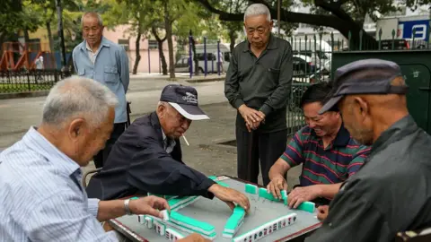 Getty Images Men play mah-jong in a street