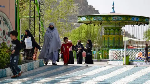 AFP Afghan people visit an amusement park in Kabul on March 28, 2022.