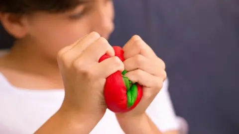 Shutterstock person squishing a squishy