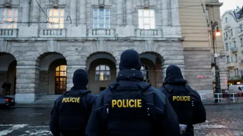 Members of the police stand guard following a shooting at one of Charles University's buildings in Prague, Czech Republic