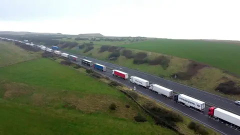 PA Media Lorries queue on the A20 at Capel-le-Ferne for the Port of Dover in Kent, on 11 January 2022