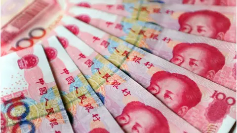 FREDERIC J. BROWN/Getty Images Yuan bank notes